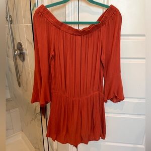 Orange romper with bell sleeves
